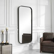 Uttermost Concord tall iron wall mirror with black finish, featuring a sleek, modern design and reflective glass surface.