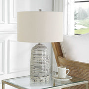 Uttermost Cyclone ivory table lamp with textured ceramic base and fabric shade, ideal for modern or contemporary decor.