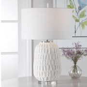 White textured Caelina table lamp by Uttermost with a modern design, featuring a cylindrical base and fabric shade.