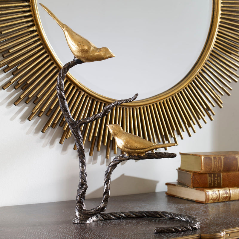 Black and gold "Birds On A Limb" sculpture by Uttermost, featuring detailed birds perched on a decorative limb.