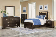 Signature Design by Ashley Covetown 5-piece bedroom set with panel bed, dresser, mirror, and nightstands in a modern bedroom.