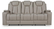 Signature Design by Ashley Elevate Edges reclining sofa with drop-down table in coin color, showcasing plush upholstery and armrests.