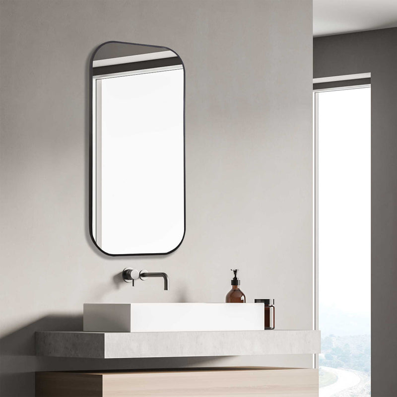 Uttermost Taft wall mirror with a sleek, modern frame, reflecting a contemporary interior style.