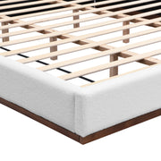 Elegant boucle upholstered bed with a wood grain textured solid wood base frame, showcasing sophisticated design by Noble House.