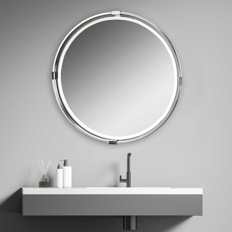 Uttermost Tazlina round wall mirror with brushed nickel frame, showcasing a sleek, modern design and reflective glass surface.