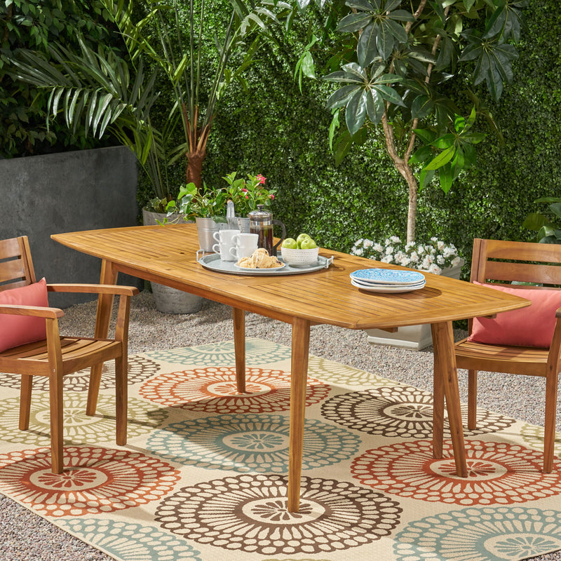 Noble House Placidity outdoor expandable dining table with slatted tabletop and tapered legs, perfect for patio dining.