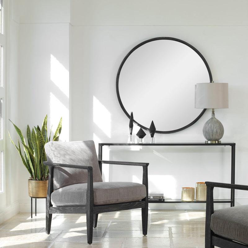 Round black accent mirror by Uttermost with a sleek frame, perfect for modern home decor.
