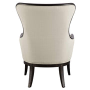 Beige and dark brown wing back armchair by Uttermost with plush upholstery and wooden legs, showcasing elegant, classic design.