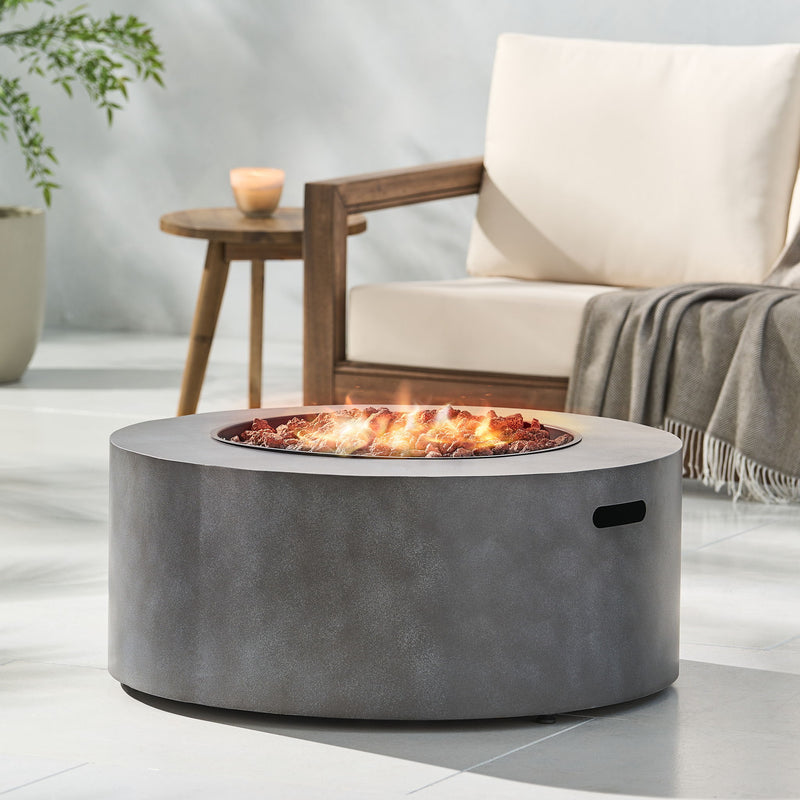 Round iron fire pit by Noble House with 40,000 Btu, featuring a sturdy design and a spacious top for outdoor fires.