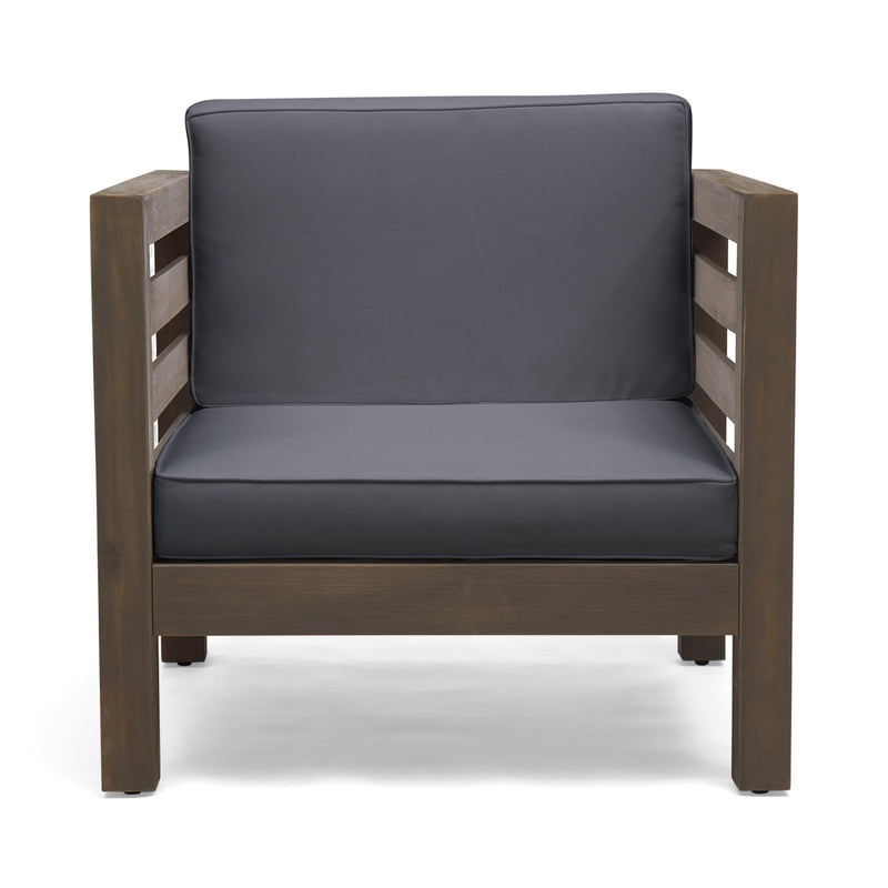 Noble House outdoor acacia wood patio arm chair with fabric cushion, showing a sturdy wooden frame and comfortable seating.