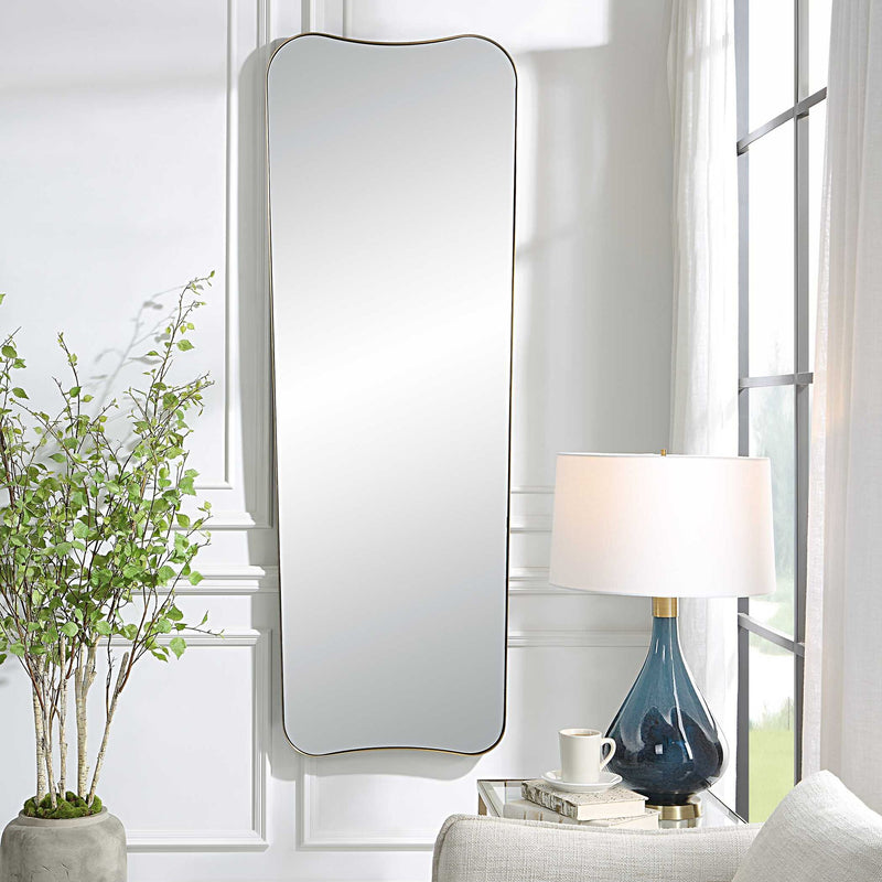 Large wall mirror by Uttermost with an antique brass finish, featuring a sleek, modern rectangular design for stylish interior decor.