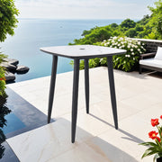 Life Outside outdoor bar table with rounded square sintered stone top, umbrella hole, rust-free frame in black or white weatherproof finish.