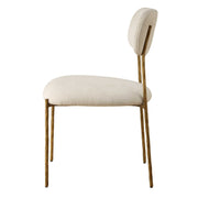 Set of two Capture dining chairs by Uttermost, gold and white with sleek modern design and cushioned seats.
