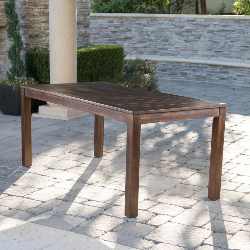 Dark brown acacia wood outdoor dining table with slatted top, ideal for garden or patio dining spaces by Noble House.