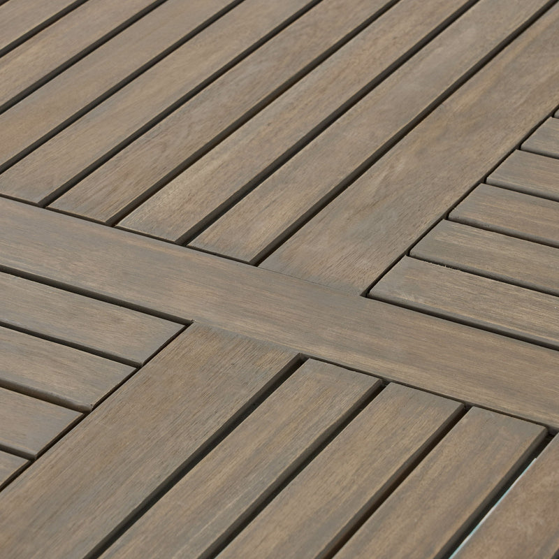 Hermosa outdoor acacia wood dining table with a circular design by Noble House, showing the textured wooden surface and sturdy base.