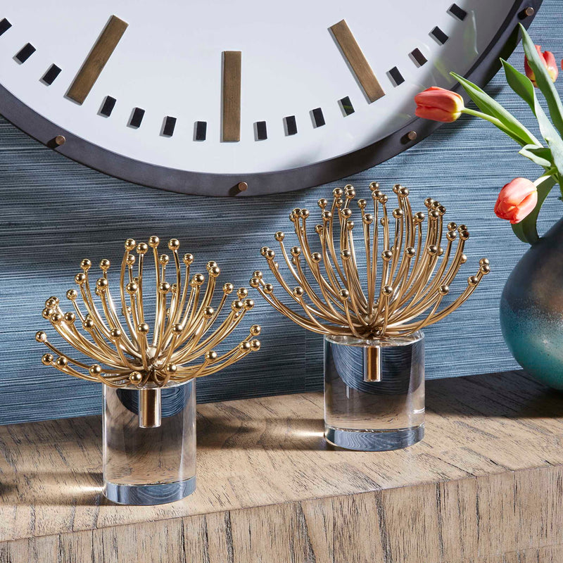 Pair of gold modern sculptures by Uttermost, featuring sleek abstract design, perfect for contemporary decor.