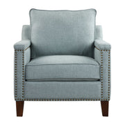 Uttermost Charlotta accent chair in Sea Mist fabric with wooden legs, showcasing a modern armchair design with plush cushioning.