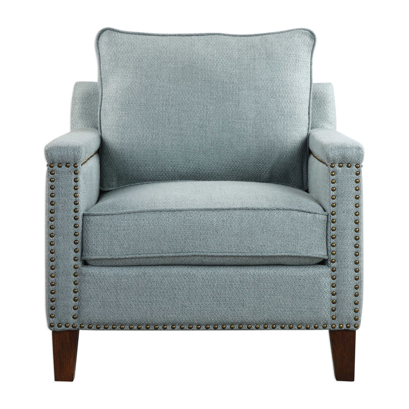 Uttermost Charlotta accent chair in Sea Mist fabric with wooden legs, showcasing a modern armchair design with plush cushioning.