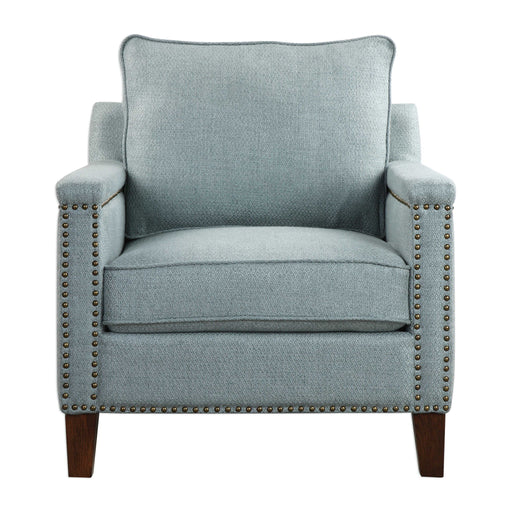 Uttermost Charlotta accent chair in Sea Mist fabric with wooden legs, showcasing a modern armchair design with plush cushioning.