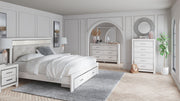 Seven-piece upholstered storage bedroom set by Signature Design Ashley®, including bed frame, nightstands, and dresser with fabric upholstery.