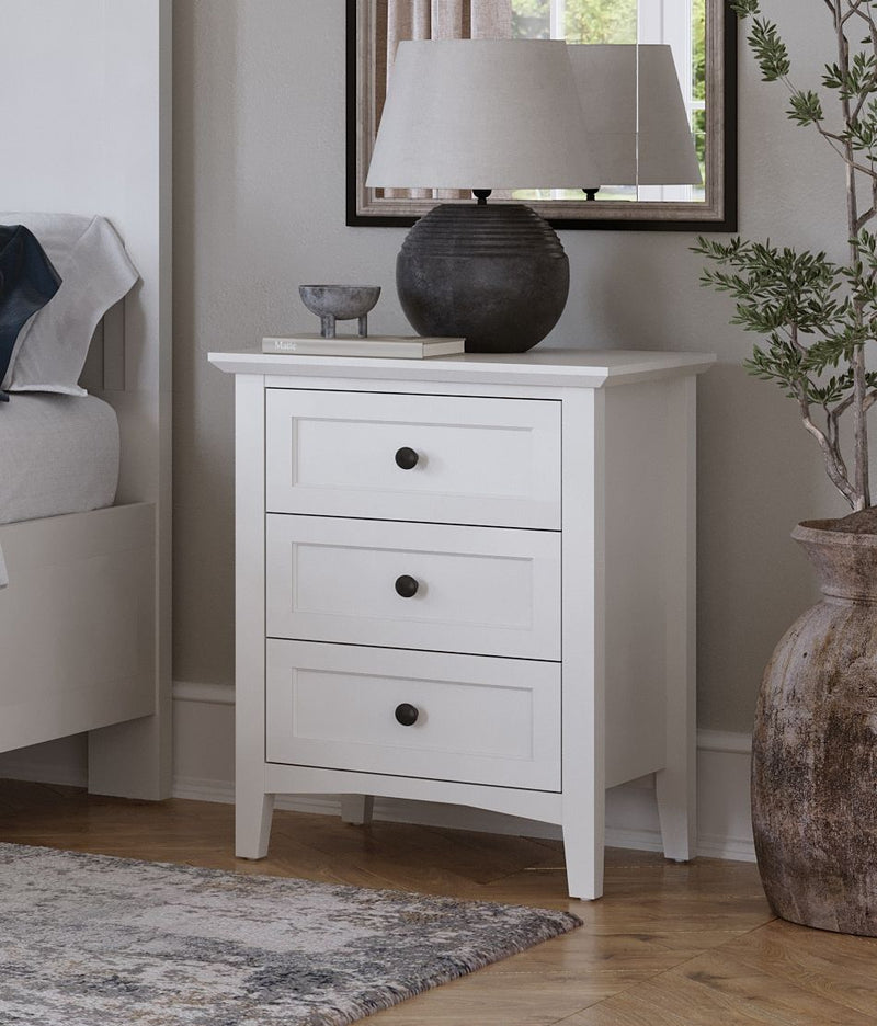 Modus Grace three drawer nightstand in snowfall white with sleek design and modern hardware, placed in a bedroom setting.