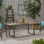Outdoor expandable acacia wood dining table with U-shaped legs from Noble House, featuring a natural wood finish and sturdy design.