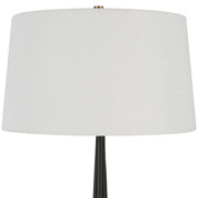Uttermost Miraz black floor lamp with sleek modern design, standing tall with a round base and a slim, elegant pole.