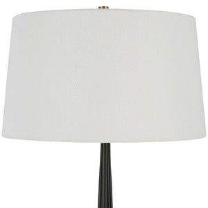 Uttermost Miraz black floor lamp with sleek modern design, standing tall with a round base and a slim, elegant pole.
