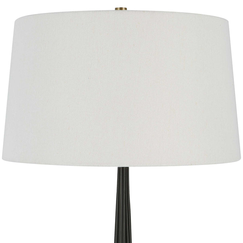 Uttermost Miraz black floor lamp with sleek modern design, standing tall with a round base and a slim, elegant pole.