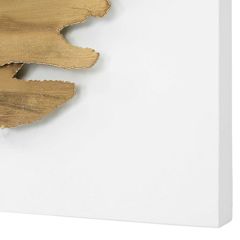 White and gold metal wall decor by Uttermost featuring an intricate, modern design for contemporary interior decoration.