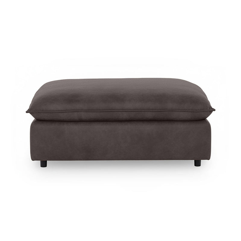 Classic Home Caplan upholstered ottoman with a plush fabric surface and wooden legs, perfect as a footrest or accent piece.