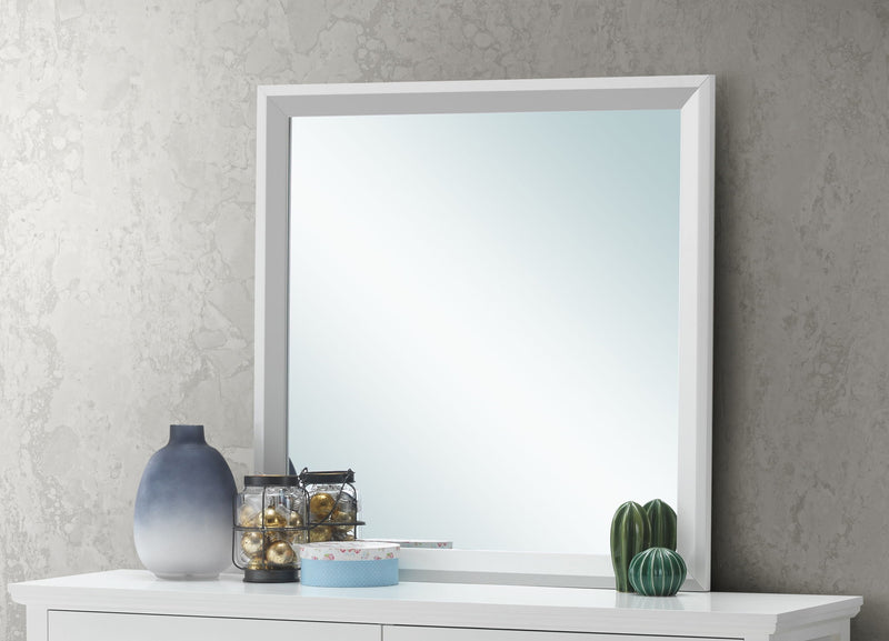 Glory Furniture Primo mirror with a sleek rectangular frame, hanging on a wall, reflecting a bright room interior.