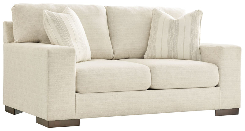 Signature Design by Ashley Maggie stationary loveseat with plush fabric and cushioned seats, perfect for cozy living room seating.
