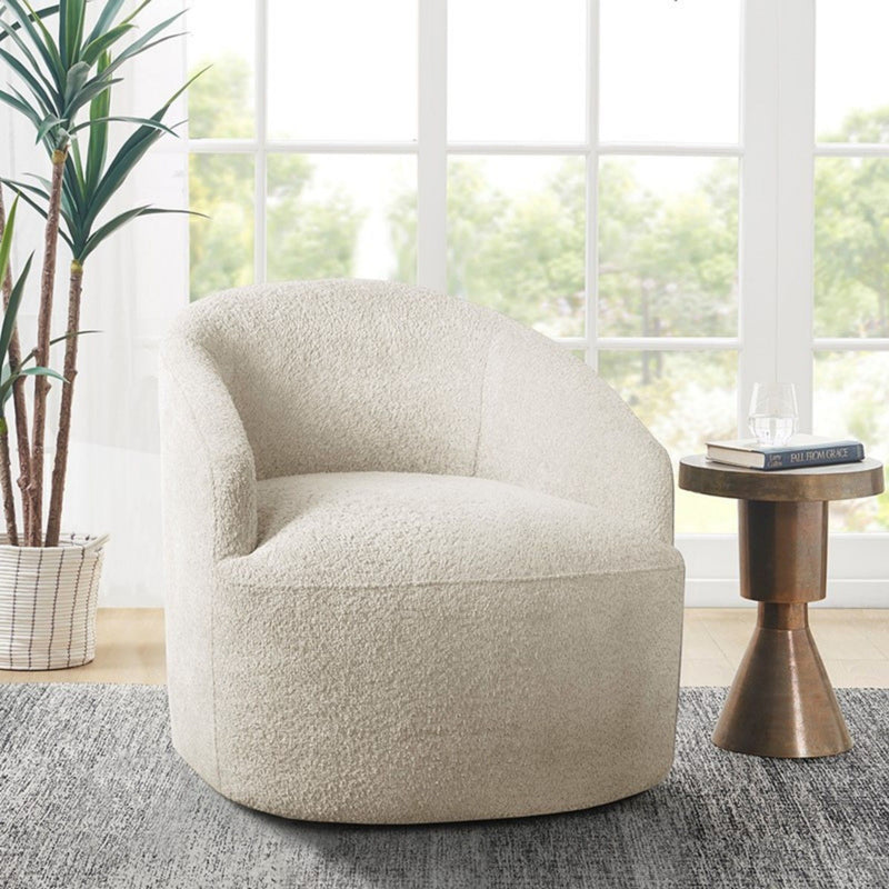 Cream upholstered JLA swivel chair with 360-degree rotation and modern design, shown from a side angle.