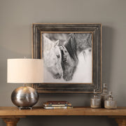 Framed print of black and white horses on dark brown background by Uttermost, showcasing detailed horse artwork for home decor.
