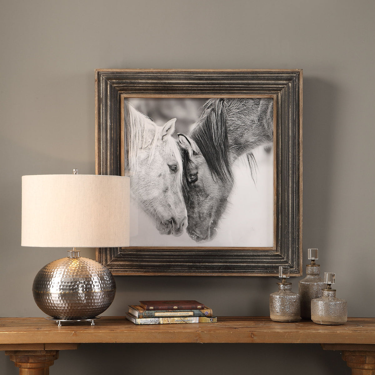 Framed print of black and white horses on dark brown background by Uttermost, showcasing detailed horse artwork for home decor.