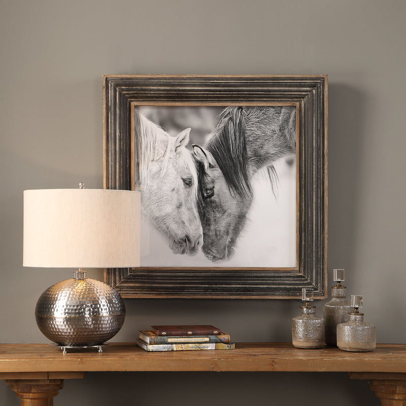 Framed print of black and white horses on dark brown background by Uttermost, showcasing detailed horse artwork for home decor.
