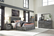 Gray Baystorm 8-piece panel bedroom set by Signature Design Ashley, featuring a bed, dresser, mirror, and matching bedroom furniture.