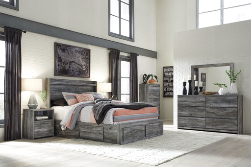 Gray Baystorm 8-piece panel bedroom set by Signature Design Ashley, featuring a bed, dresser, mirror, and matching bedroom furniture.