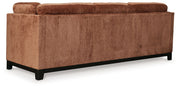 Ashley® Laylabrook plush upholstered sofa in bold spice color with dark wood trim, featuring a stationary design for living room comfort.