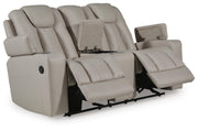 Signature Design by Ashley Elevate Edges Glide Reclining Loveseat with console in coin fabric, featuring plush cushions and built-in cup holders.