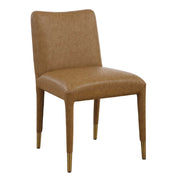 Pair of Uttermost Conifer dining chairs with wooden legs and upholstered seats, showcasing elegant, modern design.