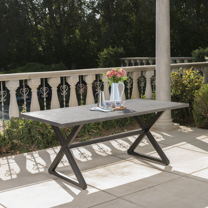 Outdoor aluminum dining table with steel frame by Noble House, featuring a sleek design for outdoor patio or garden use.