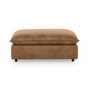 Classic Home Caplan upholstered ottoman with tufted fabric and wooden legs, designed for versatile living room use.