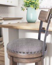 Caitbrook - Tall UPH Swivel Barstool - Gray - R&R Furniture Gallery (Fountain Valley, CA)