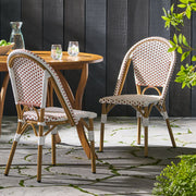 Outdoor rattan and aluminum French bistro chair set by Noble House, featuring woven rattan seats and sleek metal frames.