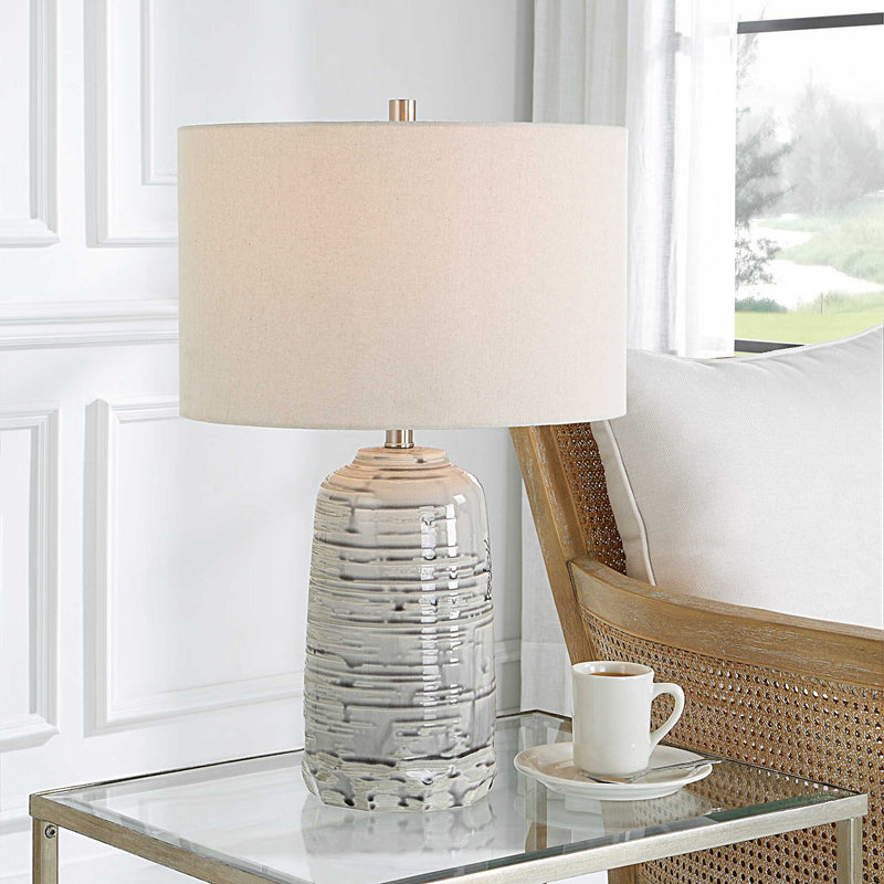 Uttermost Cyclone ivory table lamp with textured base and fabric shade, ideal for modern or classic home decor.