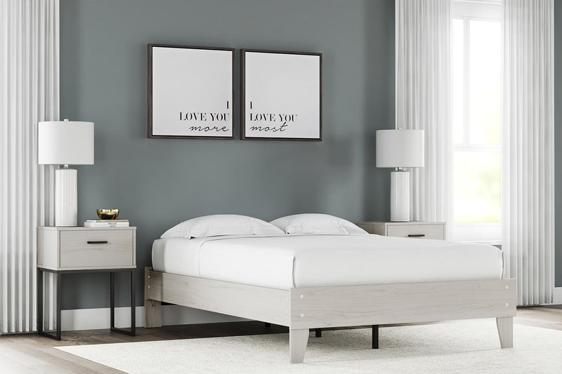 Signature Design by Ashley Socalle platform bed with a sleek wooden frame and modern headboard design.