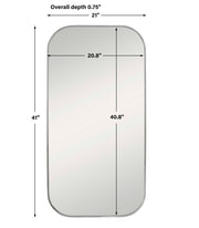 Uttermost Taft wall mirror with a sleek, modern frame hanging on a wall, showcasing its stylish design and reflective surface.