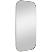 Uttermost Taft wall mirror with a sleek, modern frame, hanging on a wall, reflecting a stylish interior space.